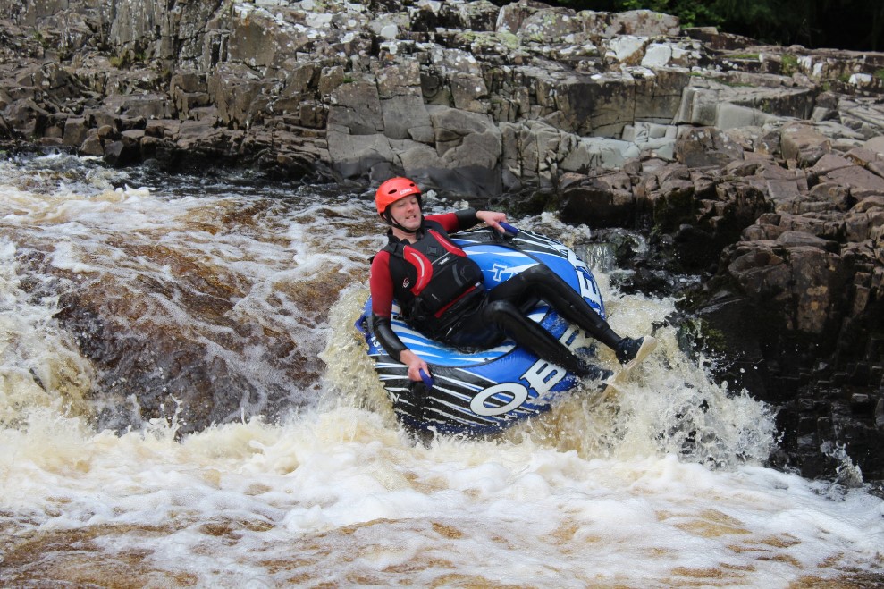 Man tubing on the River Tees rapids