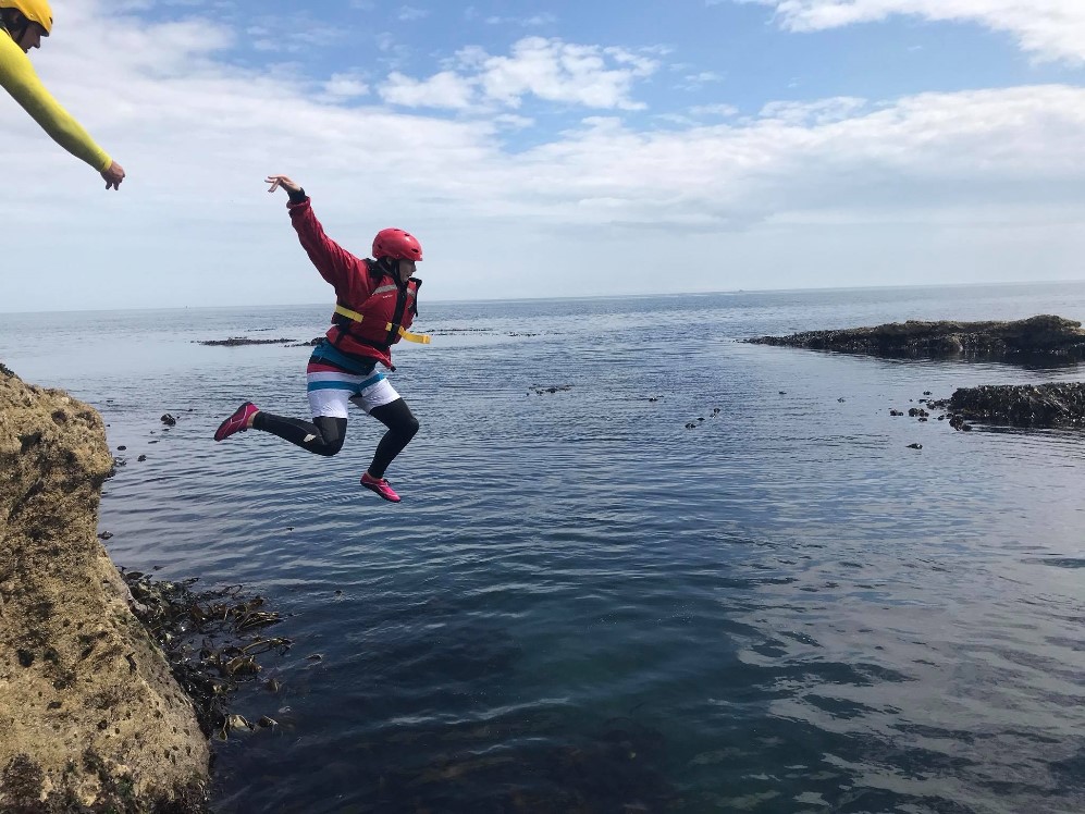 Woman cliff jumping in the North East