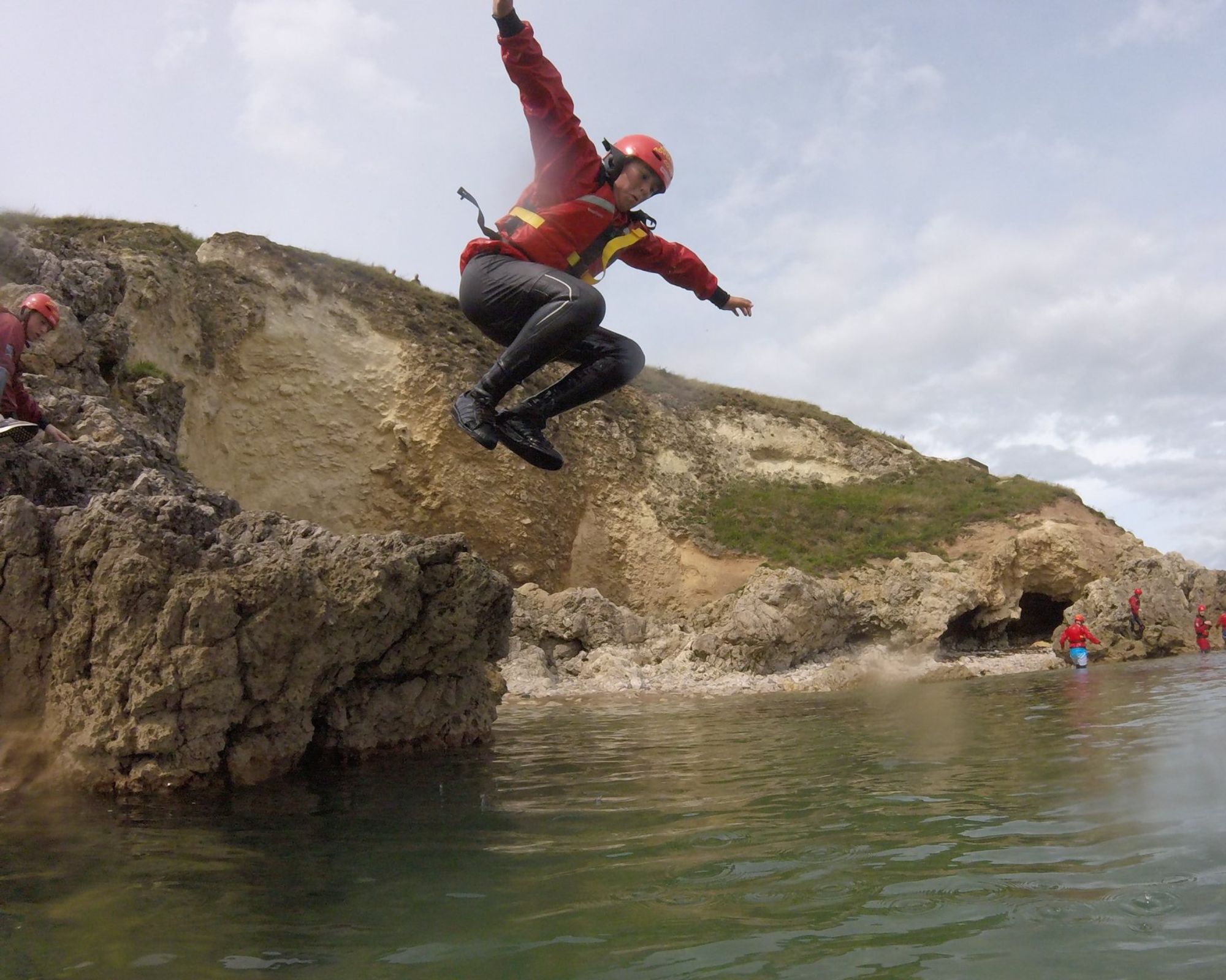 Man leaping into the sea on a coasteering adventure